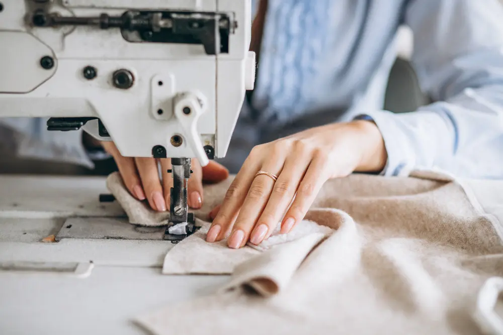 A girl is working on sewing machine.